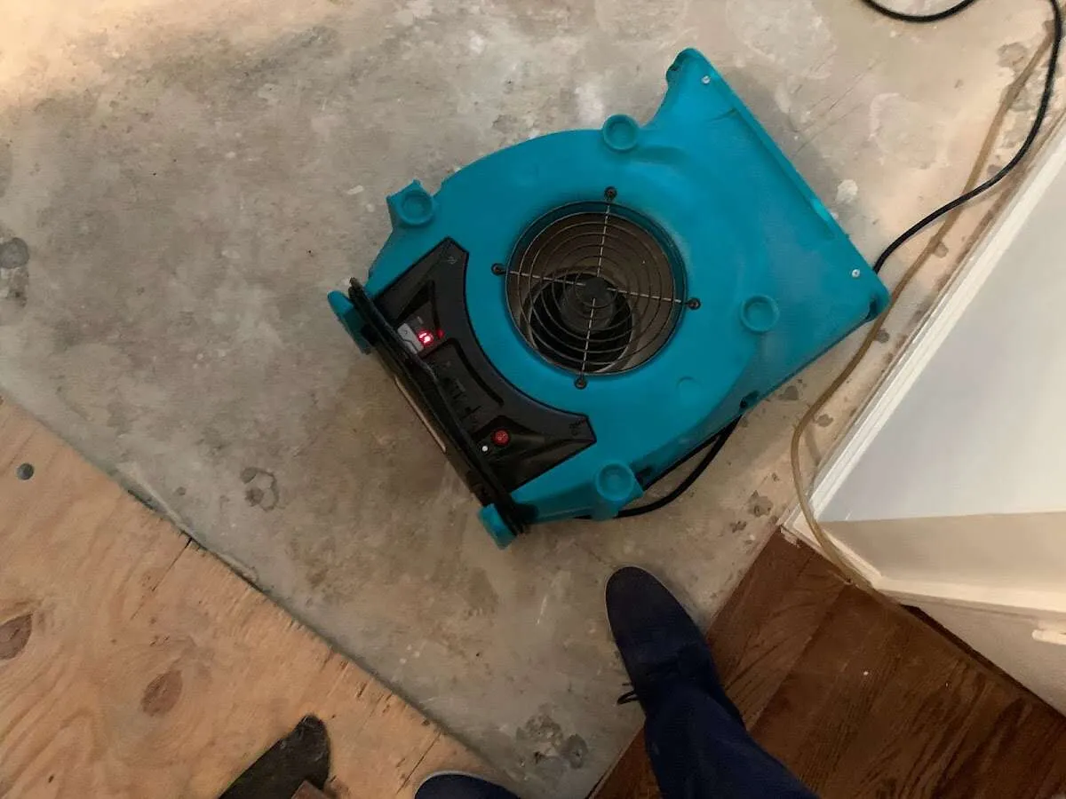 Air mover drying subfloor during Commercial Water Damage Restoration in Rancho San Diego